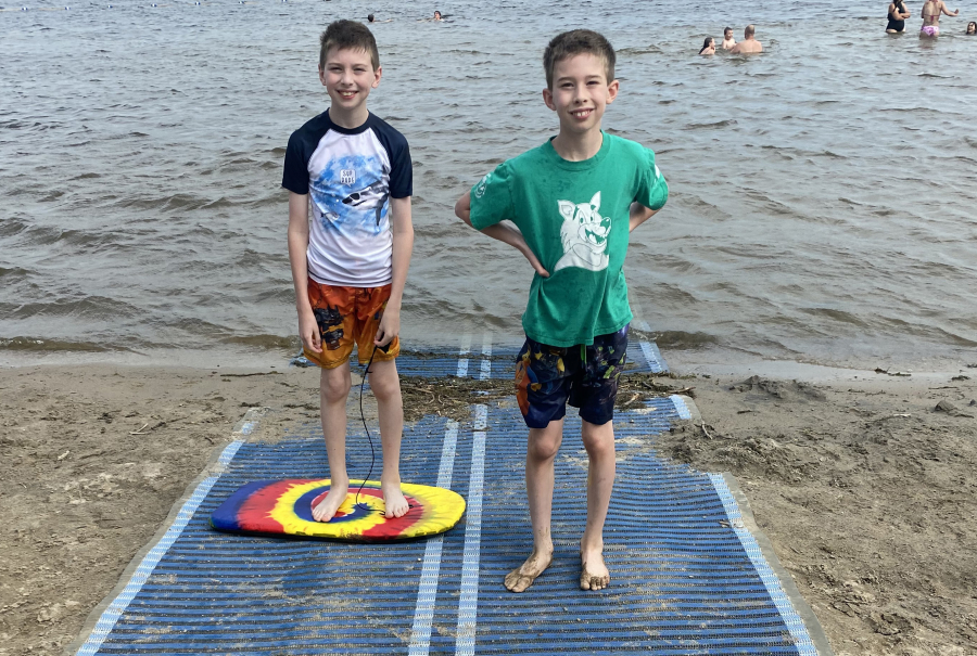 Phil and Michel Charron check out the new accessible beach mat at Baxter beach.